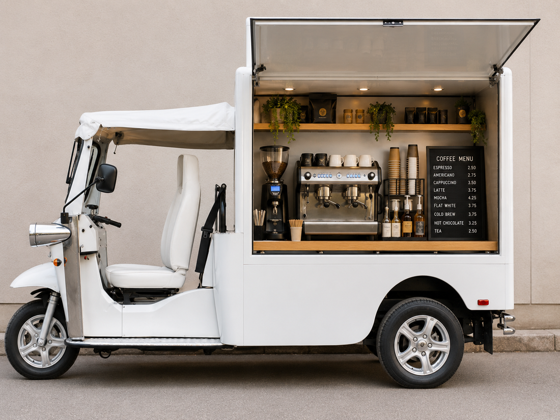 White eTuk Vendo mobile coffee vehicle showing espresso equipment, menu and service opening